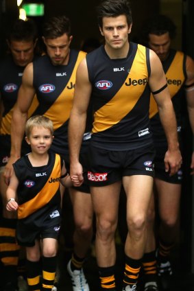 Trent Cotchin leads the Tigers onto the ground.