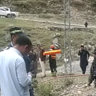 Police officers examine the site of suicide bombing at a highway in Shangla, north-west Pakistan.