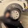 The driver sits against the edge of the fountain as police test for alcohol.