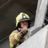Firefighters inspect the damage at Melbourne’s Neo 200 building.
