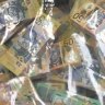 Police seize $1.8 million in cash stacked on CBD hotel coffee table