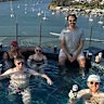 Friends relaxing in a rooftop pool in Newstead.