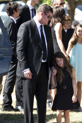 James Packer, with one of his three children, attended the funeral in Gunnedah.