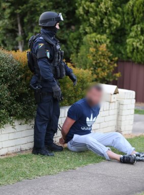 A man is arrested in Lockwood Street, Merrylands.