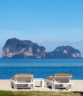 Sunloungers with an island-dotted sea.
