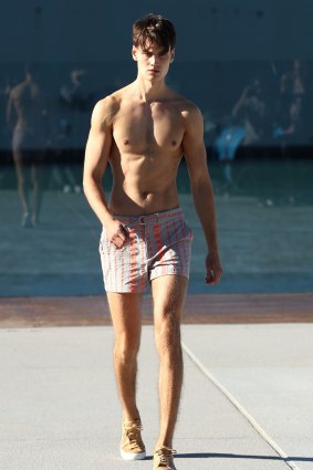 A model walks the runway  - the deck of the Andrew Boy Charleton Pool - at the Katama by Garrett Neff show.