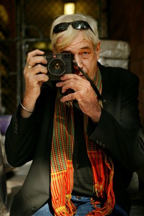 Photojournalist Tim Page, who  has covered major conflicts including the Vietnam war, with his Leica camera.