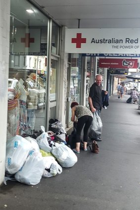 People helping themselves to donations left in front of a Red Cross store in Richmond on Monday. 