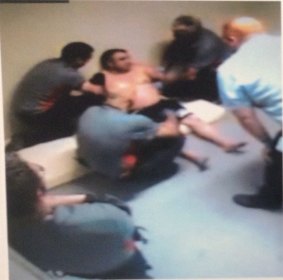 A CCTV still of security guards restraining Turkish national Mustafa Bektas at Maribyrnong detention centre. 