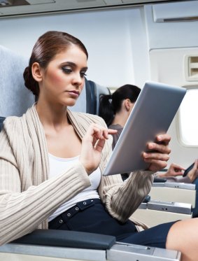 Flying tips.
Young woman sitting on the airplane and using a digital tablet.
str12cover