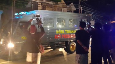Indonesia police transfer prisoners from the rival gangs from Kerobokan jail to other prisons in Bali. On the side of the police bus it says "prisoner car - anti-thuggery".