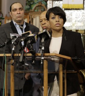 Baltimore mayor Stephanie Rawlings-Blake speaks in front of faith and community leaders at a news conference calling for peace.