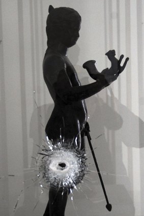 A bullet hole is seen on a showcase during the reopening of the National Bardo Museum in Tunis on Friday.  