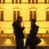 Romantic spot: A couple in front of parliament building, Budapest, Hungary.