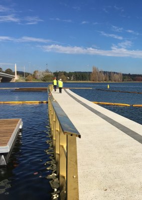 Andrew Barr and Mick Gentleman check out the first part of the West Basin boardwalk on Tuesday. At the end is a wooden platform with steps to the water. The photograph looks towards Parliament House.