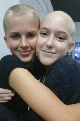 Annaleise (right) with her friend Jaime, who shaved her head to support her friend.
