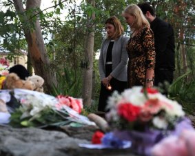 Minister for the Prevention of Domestic and Family Violence Shannon Fentiman and Parkinson Ward councillor Angela Owen-Taylor pay their respects at a candelight vigil for Queenie Xu in a park across the road from where she was stabbed to death in Parkinson.