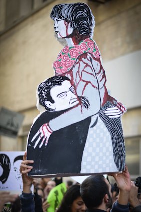 An Egyptian demonstrator holds a placard depicting Shaima al-Sabbagh.