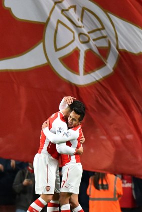 Our goal: Arsenal’s Olivier Giroud (left) hugs Alexis Sanchez .