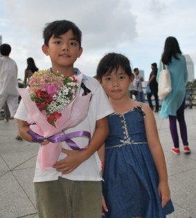 Two young children paid their respects to the late leader on the banks of the Singapore River.