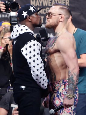 Face off: Floyd Mayweather Jr. and Conor McGregor face each other during a promotional event.
