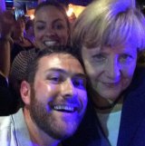 Angela Merkel poses for photo with revellers at Catxton Street on Friday night.