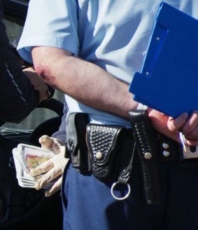 Police search a car near the home of Omarjan Azari in September 2014.