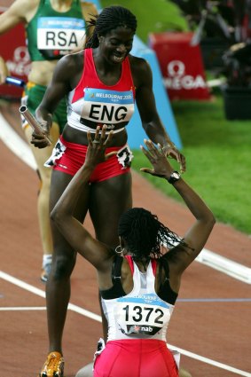 England's Natasha Danvers pretends to worship teammate Christine Ohuruogu after the 2006 Commonwealth Games relay.