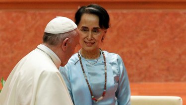 Pope Francis walks past Myanmar leader Aung San Suu Kyi during their meeting at the International Convention Centre of Naypyitaw, Myanmar.