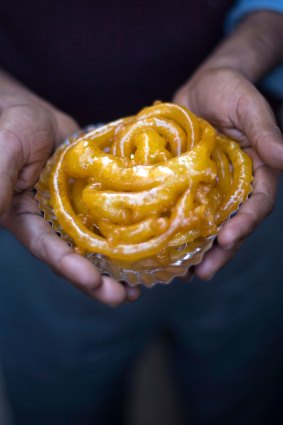 A man holds jalebis at the Old & Famous Jalebi Wala.  