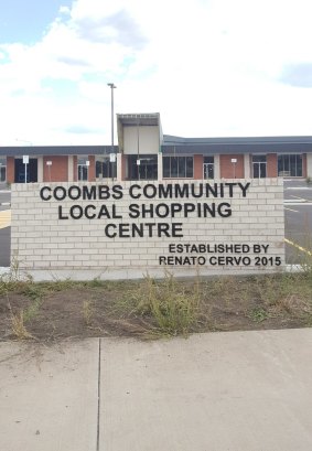 Residents say the sign outside the yet-to-be-finished Coombs shopping centre graphically illustrates their long wait for local shops.