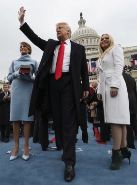 President Donald Trump (C) with First Lady Melania Trump (L) and daughter Tiffany (R) in her Aruna Seth boots.