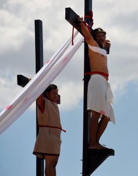 Reuben Enaje (right cross) playing the role of Jesus during the Passion Play a re-enactment of Christs crucifixion, on Good Friday.