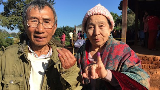 Voters in Kalaw, Myanmar, display their inked fingers after voting in the national election. 