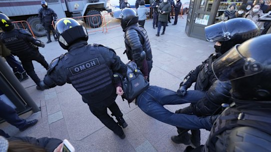 Police detain a demonstrator during an action against Russia's attack on Ukraine in St. Petersburg, Russia, Sunday, Feb. 27, 2022. Protests against the Russian invasion of Ukraine resumed on Sunday, with people taking to the streets of Moscow and St. Petersburg and other Russian towns for the third straight day despite mass arrests. (AP Photo/Dmitri Lovetsky)
