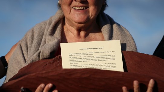 Pat Anderson from the Referendum Council with a piti holding the Uluru Statement from the Heart, during the closing ceremony in the Mutitjulu community of the First Nations National Convention at Uluru.