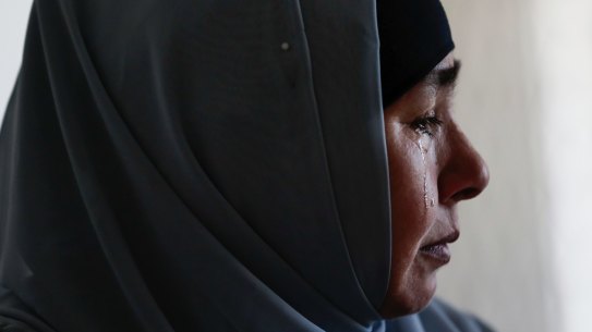 Horigul Yusuf sheds tears as she speaks about her brother Abdulahad Yusuf who is in an internment camp, in Adelaide on 10 November 2018. fedpol Photo: Alex Ellinghausen (Feature of Uighur community living in Adelaide) uighurfeature