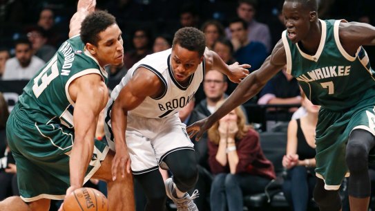 Thon Maker (right) applies the pressure as Bucks guard Malcolm Brogdon strips the ball from Nets guard Yogi Ferrell.