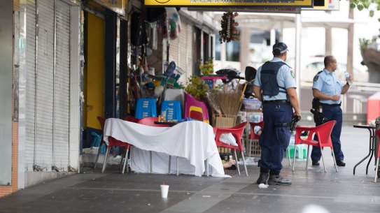 Police guard the crime scene where the criminal lawyer was shot dead.