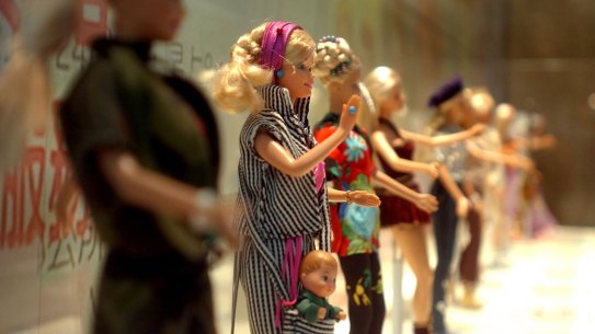 Barbie dolls in various outfits at the makeshift Barbie museum, in 2004. 