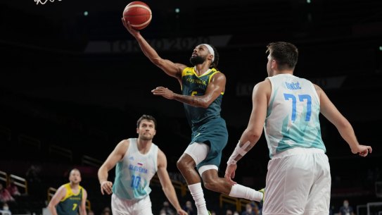 Australia's Patty Mills (5) puts up a shot against Slovenia's Luka Doncic (77) and Mike Tobey (10) during the men's bronze medal basketball game at the 2020 Summer Olympics, Saturday, Aug. 7, 2021, in Tokyo, Japan. (AP Photo/Eric Gay)