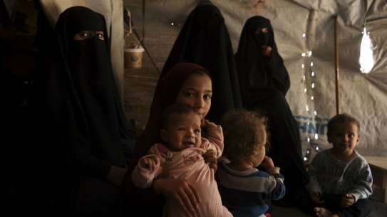 Australian Maysa Assaad, 9 (3rd from left), holding Shayma Assaad's daughter Mariam (2nd from left) in Al-Hawl camp in North East Syria. 