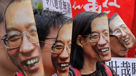Protesters wear masks of Chinese Nobel Peace laureate Liu Xiaobo during a demonstration demanding his release outside the Chinese liaison office in Hong Kong in June 2017.