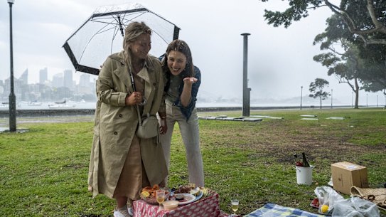 A pinic is disrupted due to heavy rain. Rushcutters Bay, September 18, 2021. Photo: Rhett Wyman/SMH