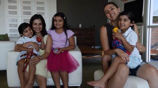 Freny Kalapesi with her three young children and her babysitter, Stephanie Palmer.