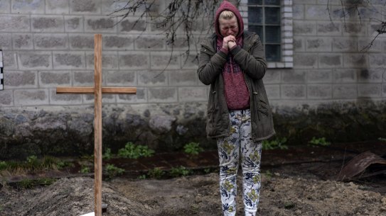 Mariya Ol'hovs'ka mourns the death of her 72-year-old father Valerii Ol'hovs'kyi, killed by a Russian missile days earlier near his home, on the outskirts of Kyiv, Ukraine, Friday, April 1, 2022. Maria and her family buried her father in the garden of their home as they could not bury him in the village cemetery due to fighting between the Ukrainian and Russian armies.