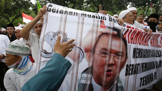 Muslim protesters hold a banner calling for the arrest of Jakarta Governor Basuki Tjahaja Purnama, popularly known as Ahok, outside City Hall in Jakarta.