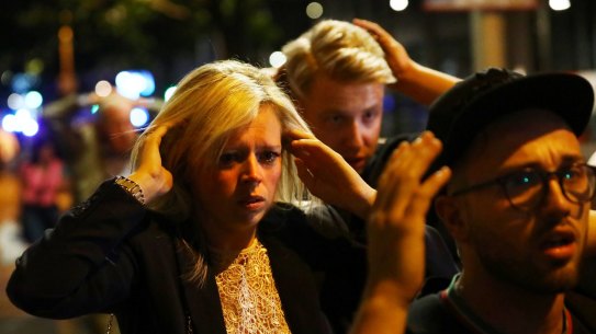 People leave the area with their hands up after the attack, Britain's third since March.