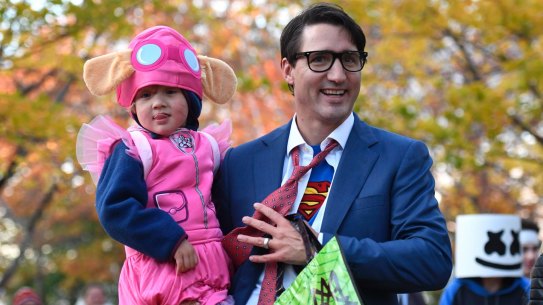 Justin Trudeau takes his youngest son Hadrien dressed as Paw Patrol character Skye trick-or-treating.