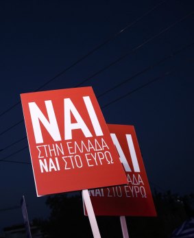 Supporters raise banners for the "NAI" or "Yes" vote during a campaign rally in support of the EU. 